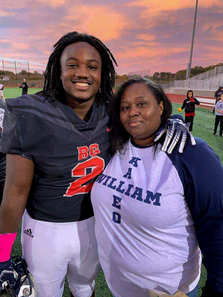 Will Henderson, left, and his mother, Tylisha Dade pose before Battle’s senior night ceremony